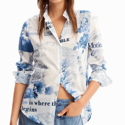 Camisa feminina azul e branca com padrão floral e texto, combinada com jeans azul claro.