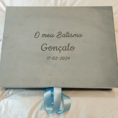Caixa cinza com texto de batismo e fita azul e branca