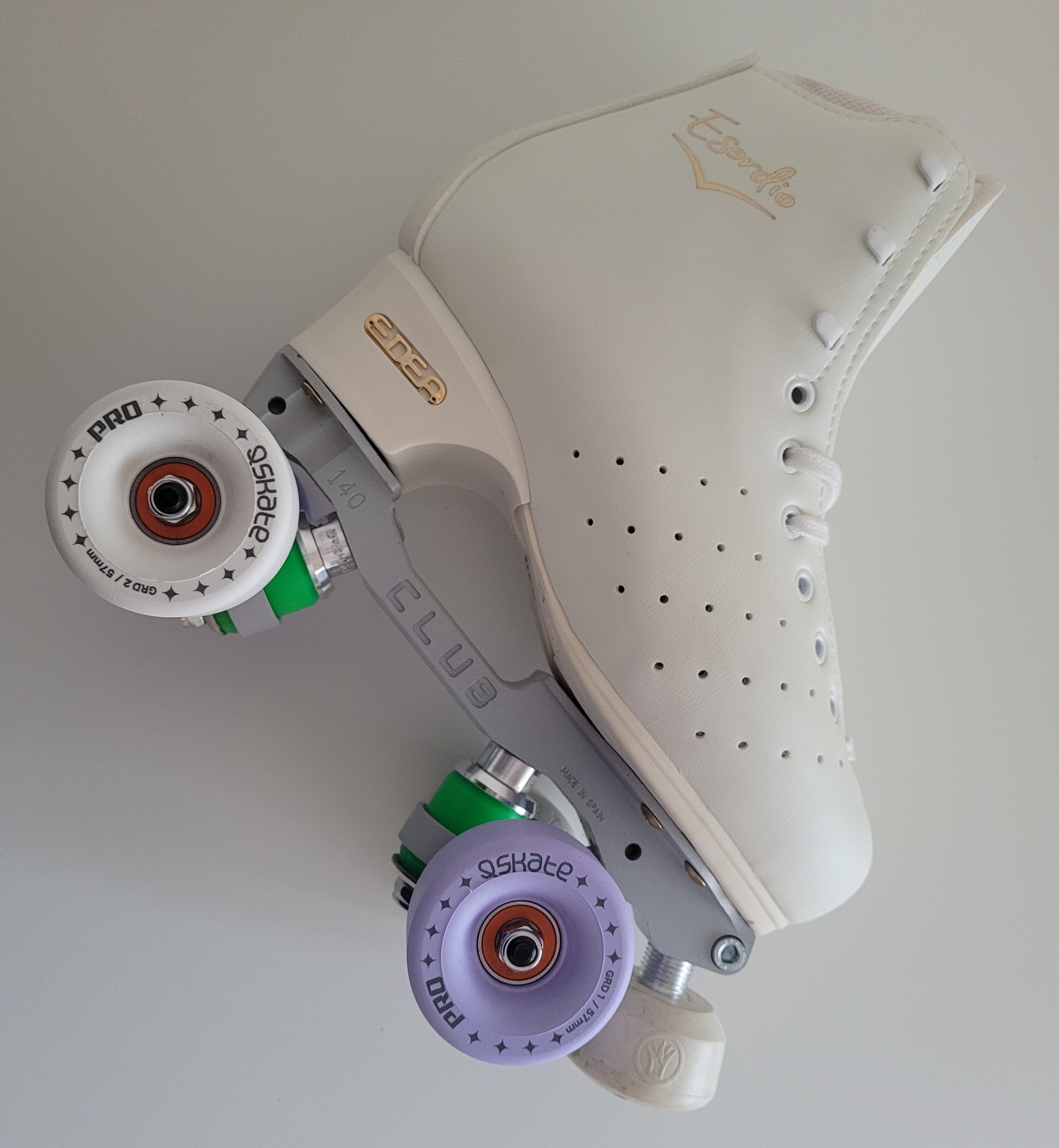 Patim de rodas branco com rodas coloridas, visto de lado