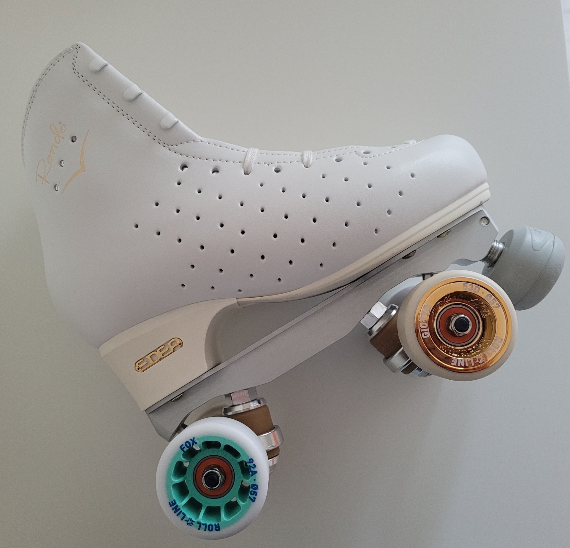 Patim de rolo clássico branco com rodas coloridas e base metálica cinzenta