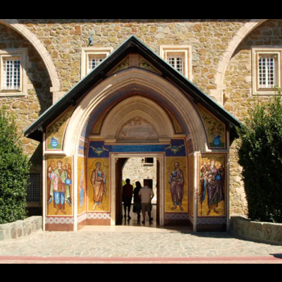Entrada de edifício em pedra com pinturas murais religiosas coloridas