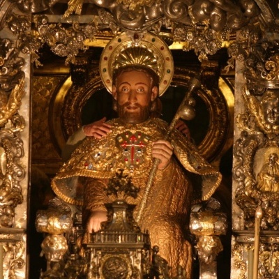 Estátua religiosa dourada num trono decorado