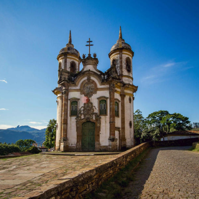 Igreja histórica com torres e fachadas verdes em ambiente ao ar livre