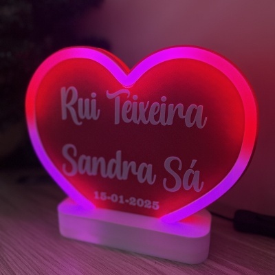Luminária de coração vermelha com iluminação rosa e roxa e nomes gravados