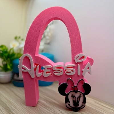 Estrutura decorativa rosa com nome Alessia e figura da Minnie Mouse