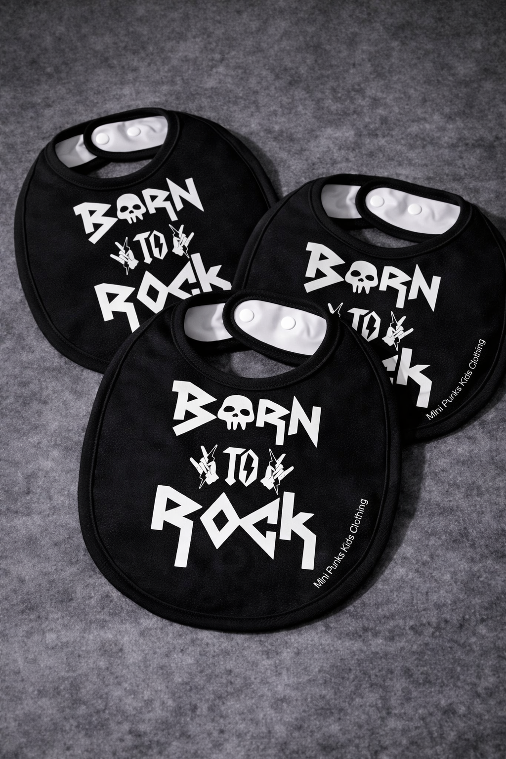 Babetes pretos para bebés com desenho branco Born to Rock, crânio e mãos de rock