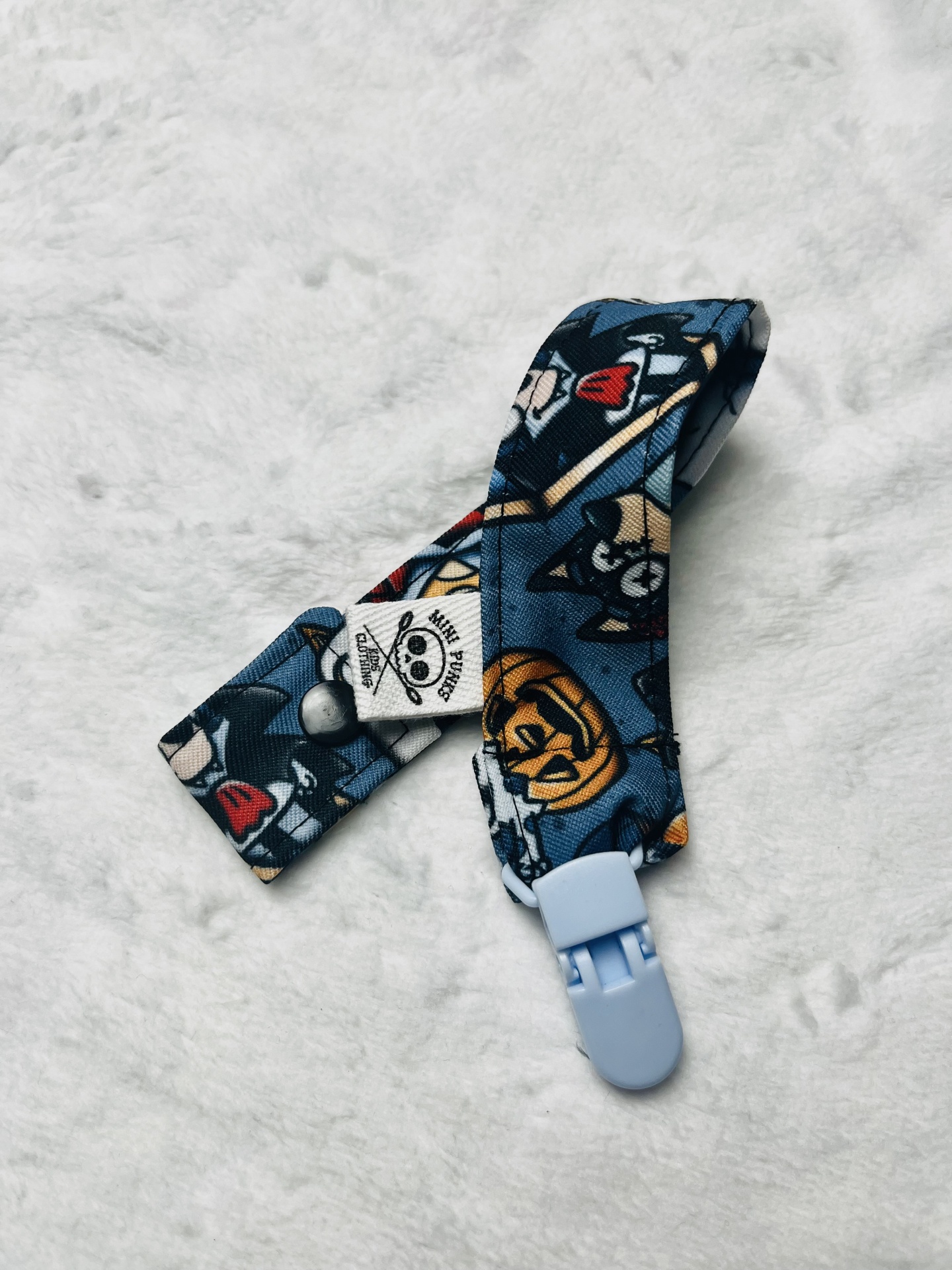 Tira para chupeta com padrão cartoon e clipe azul claro