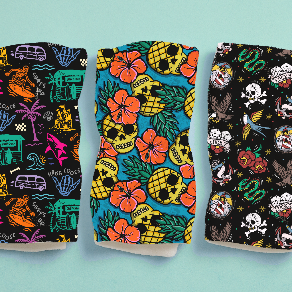 Três máscaras coloridas com padrões variados de caveiras, flores, abacaxis e texto HANG LOOSE