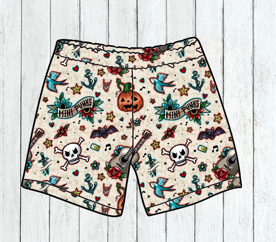 Calções coloridos com várias pequenas ilustrações de caveiras, morcegos, guitarras, âncoras e abóbora de Halloween