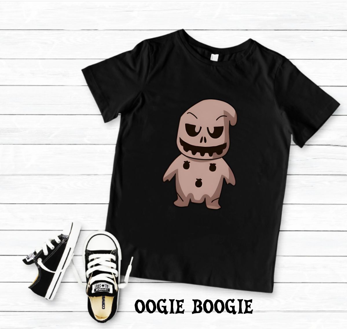 T-shirt preta com estampa de personagem Oogie Boogie e ténis infantis pretos e brancos em fundo branco.