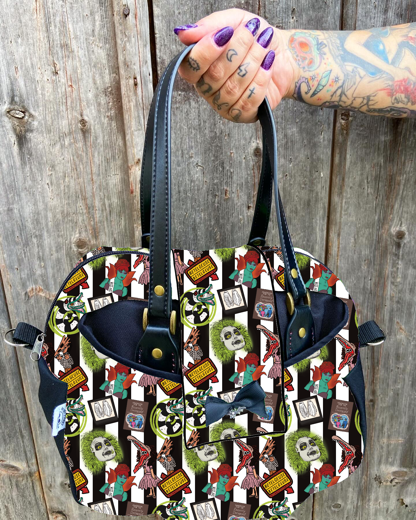 Mala colorida com vários padrões gráficos e alças pretas, segurada por mão tatuada