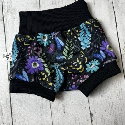 Pantalona curta para bebé com estampa floral e elementos de aranha em preto com cós e bainhas pretas