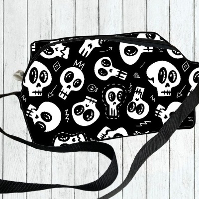 Bolsa preta com padrão branco de caveiras
