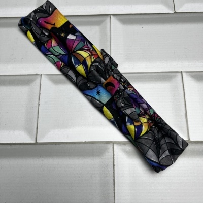 Fita de tecido colorida com padrão abstrato enrolada sobre superfície branca texturizada