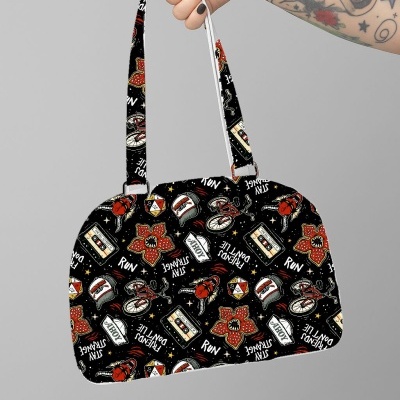 Mala preta com padrão colorido e alça ajustável