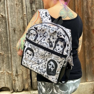 Mochila preta e branca com estampas de personagens de filmes de terror usada em pessoa