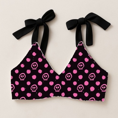 Top feminino preto com caveiras e bolinhas cor-de-rosa e alças pretas amarradas em laços