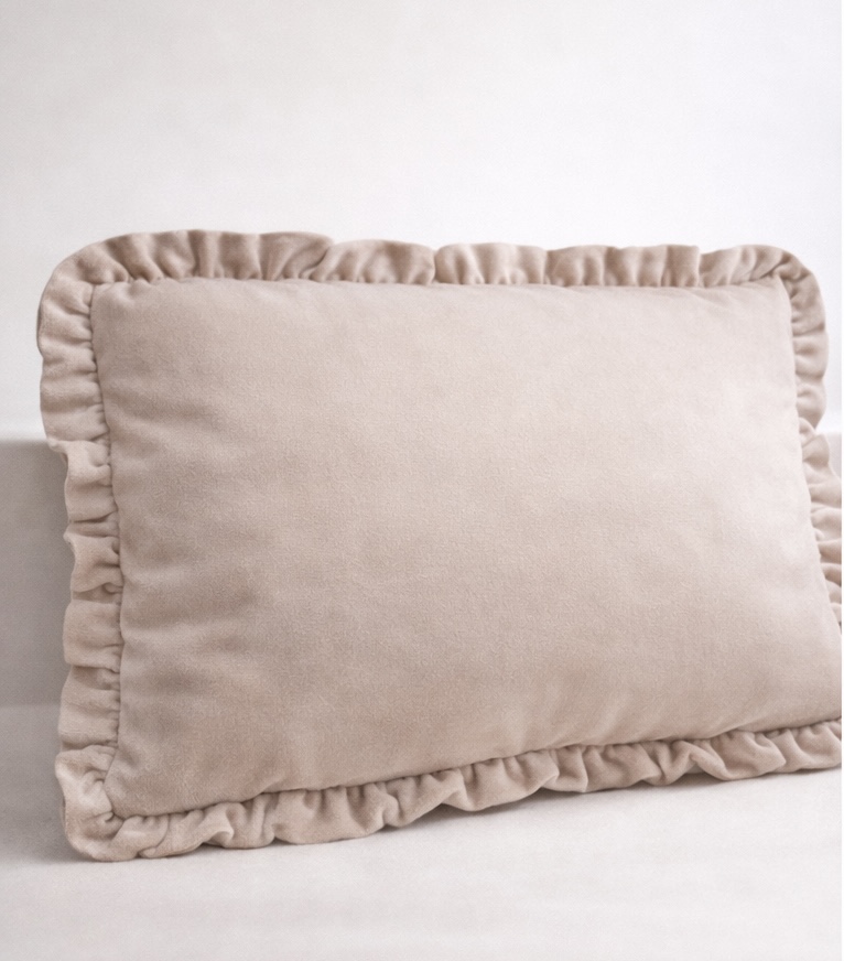 Travesseiro bege claro com borda franzida em tecido aveludado