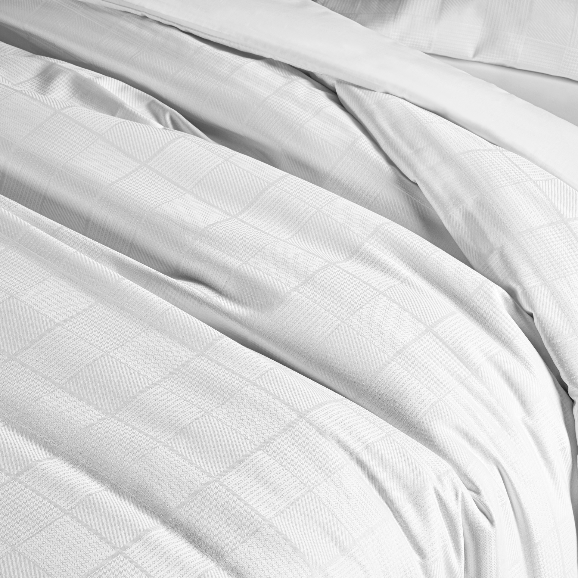 Lençol branco com padrão quadriculado texturizado