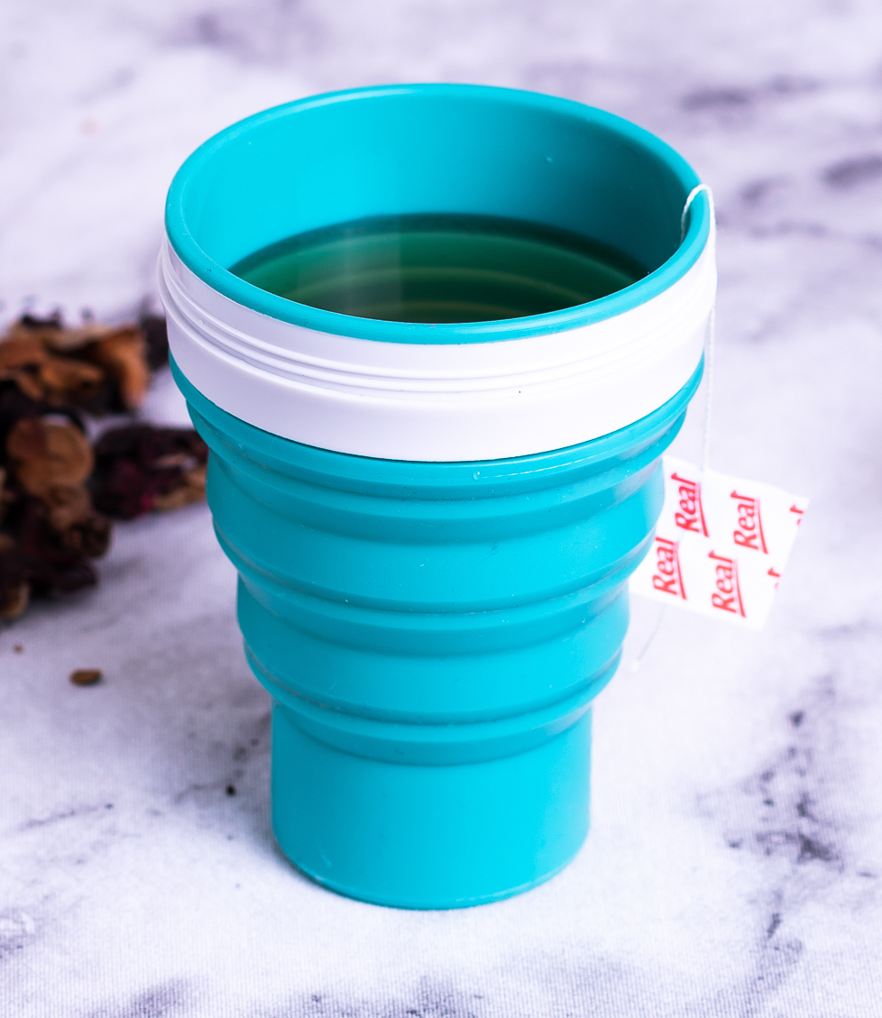 Copo retrátil azul com chá e saco de chá Real