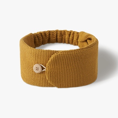Faixa amarela de tecido com botão de madeira