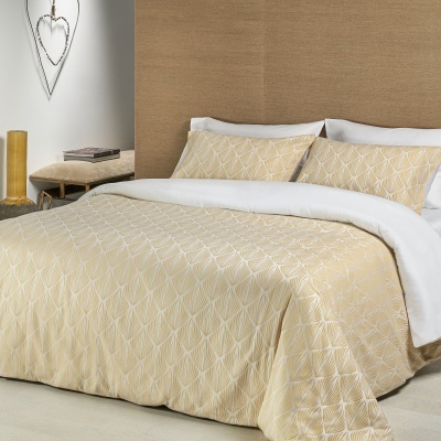 Cama de casal com colcha e fronhas bege claro com padrão geométrico branco