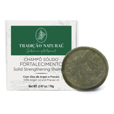 Champô sólido redondo verde com embalagem branca e rótulo verde da marca Tradição Natural.
