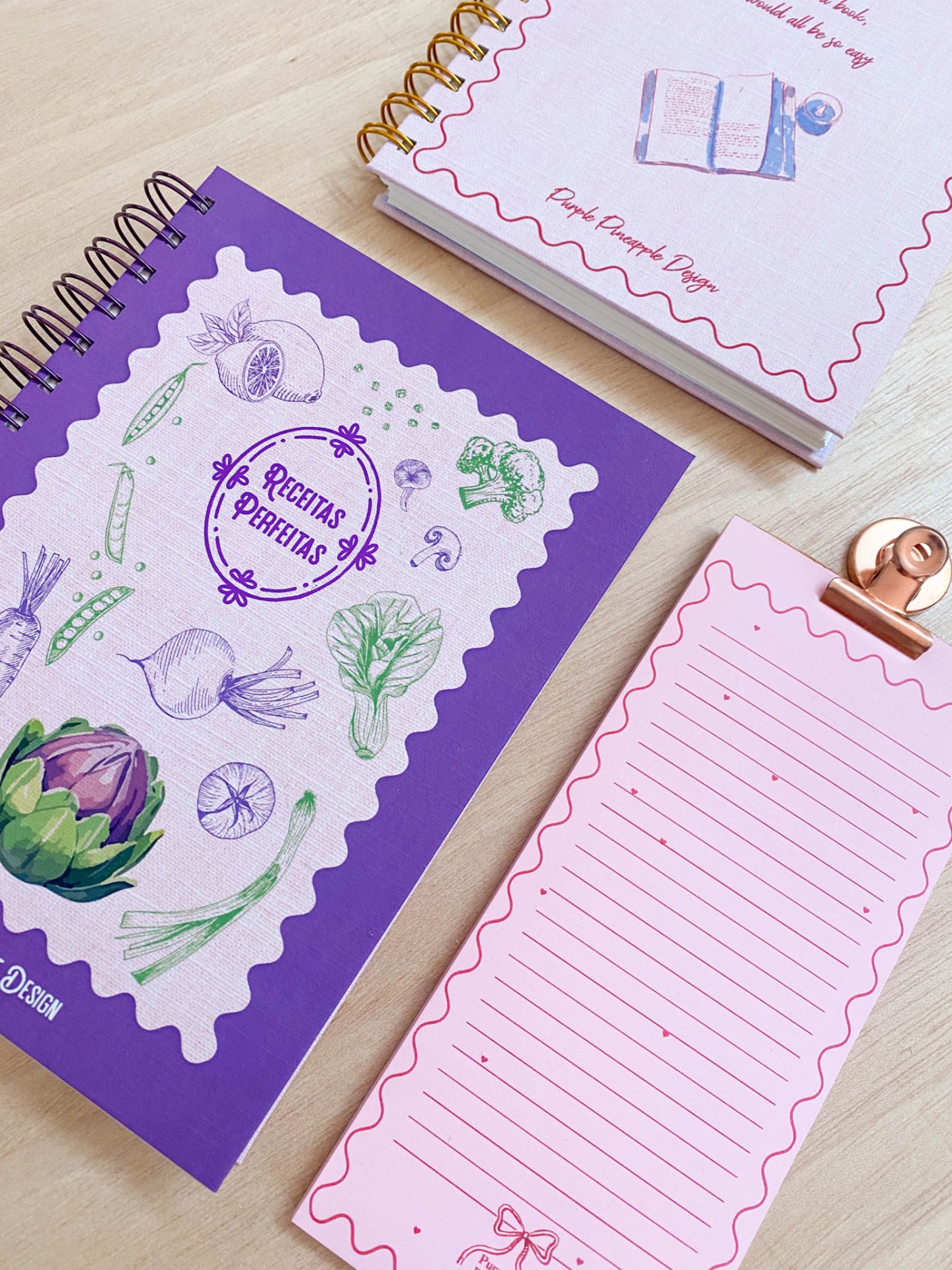 Cadernos e bloco de notas coloridos sobre mesa de madeira clara