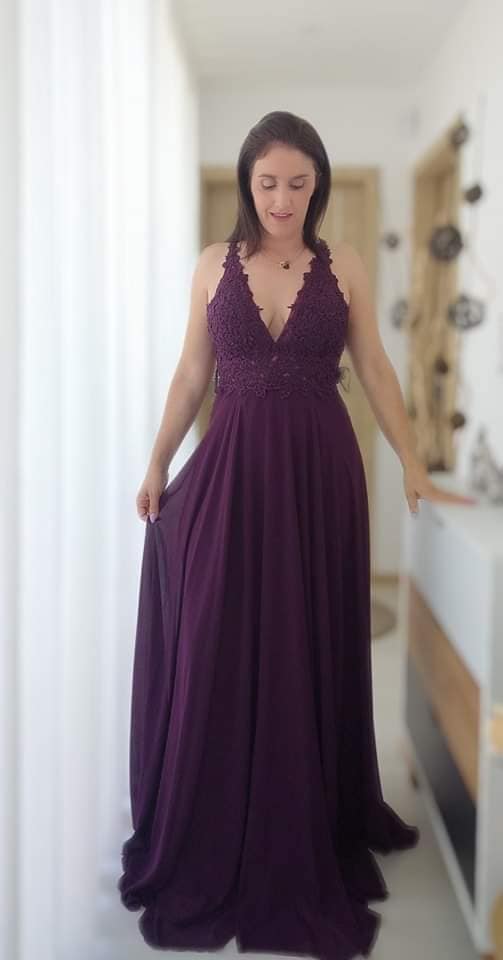 Vestido Diana Vestido longo roxo escuro com corpete em renda floral e saia fluida num interior iluminado