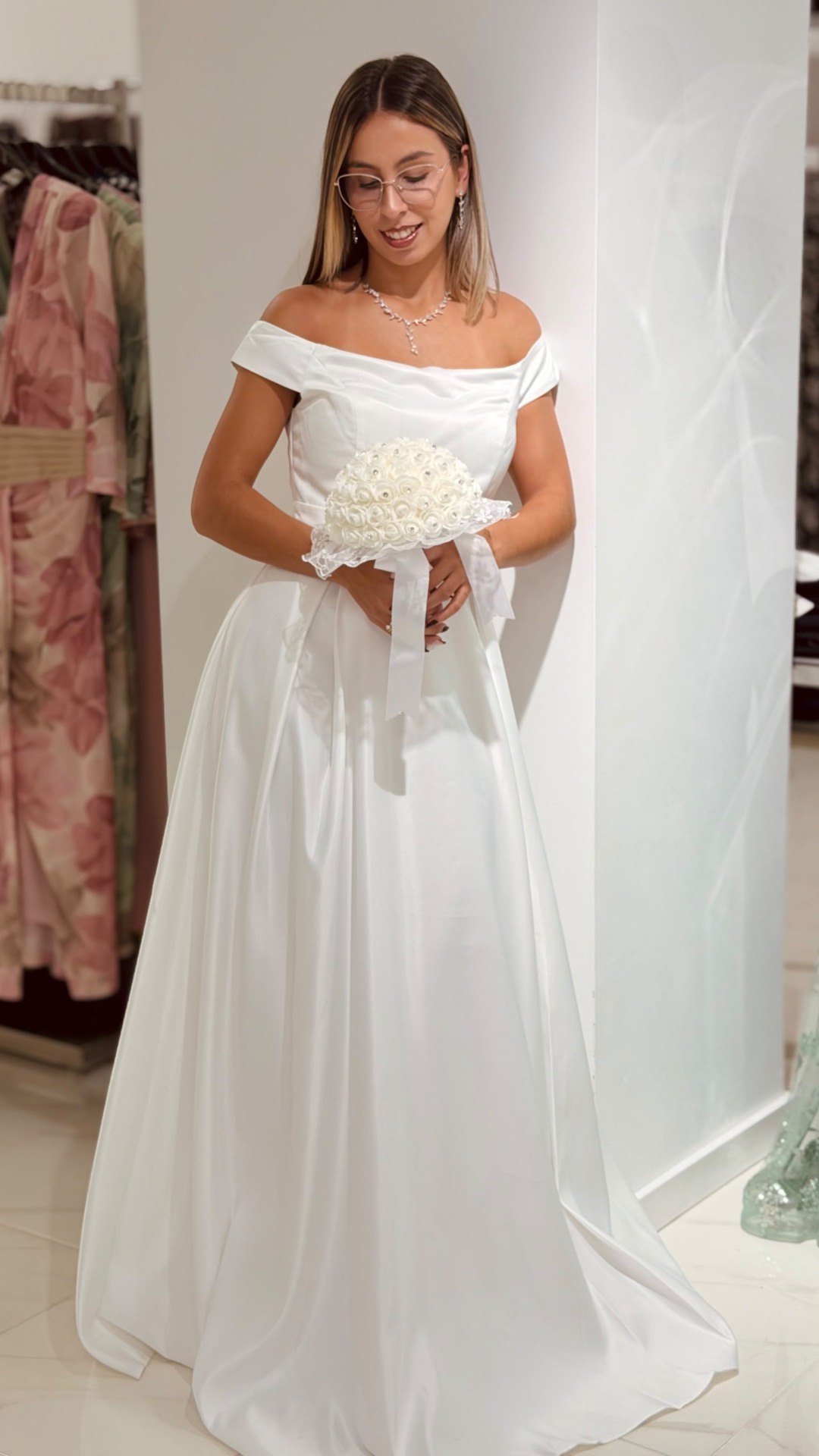 Vestido Santa Noiva Mulher com vestido de noiva branco e bouquet branco em cenário interior