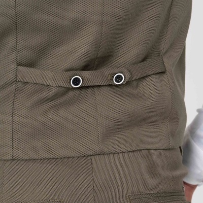 Parte traseira de colete bege ajustável com duas molas pretas e borda branca sobre camisa branca