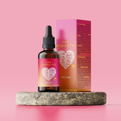 Frasco de vidro âmbar com rótulo rosa e amarelo e caixa com design semelhante em fundo rosa