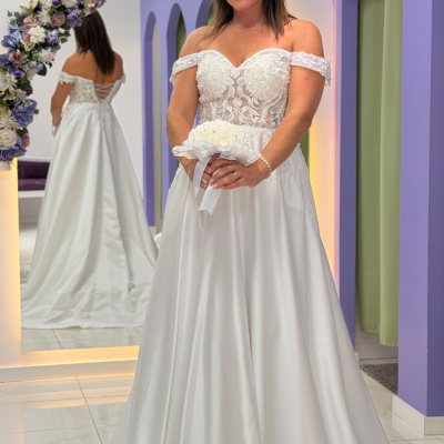 Vestido de noiva branco com corpete de renda e saia ampla em ambiente com espelho decorado