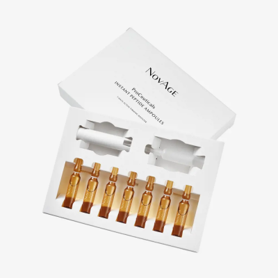 Conjunto de ampolas NovAge Proceuticals Instant Perfect Ampoules em embalagem branca com oito ampolas castanho-alaranjadas