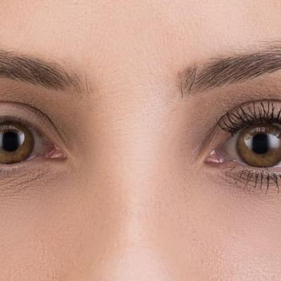 Olhos de pessoa com pestanas naturais num olho e pestanas com máscara no outro