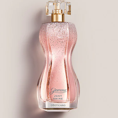 Frasco de perfume cor-de-rosa com brilho e tampa transparente dourada