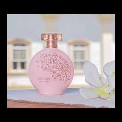 Frasco de perfume rosa decorado com flores e texto floratta