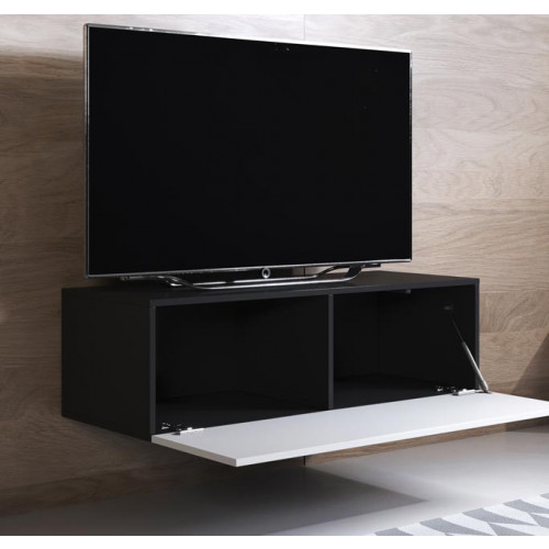Televisor preto sobre móvel suspenso preto com porta branca aberta