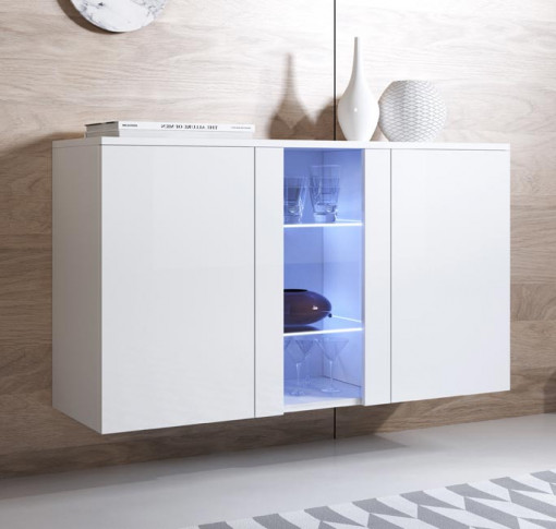 Móvel suspenso branco com porta de vidro iluminada azul no centro, copos dentro e decoração no topo