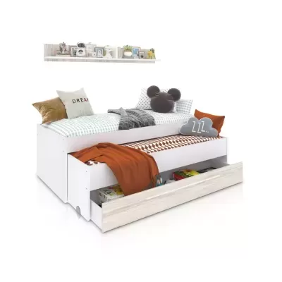Cama dupla branca com gaveta de arrumação e roupa de cama com padrões e almofadas decorativas