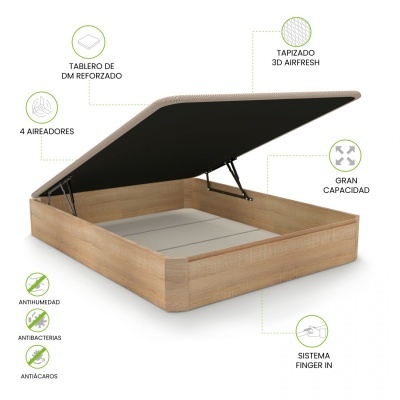 Base de cama em madeira clara com tampo estofado bege levantado, mostrando espaço interior e texto explicativo.