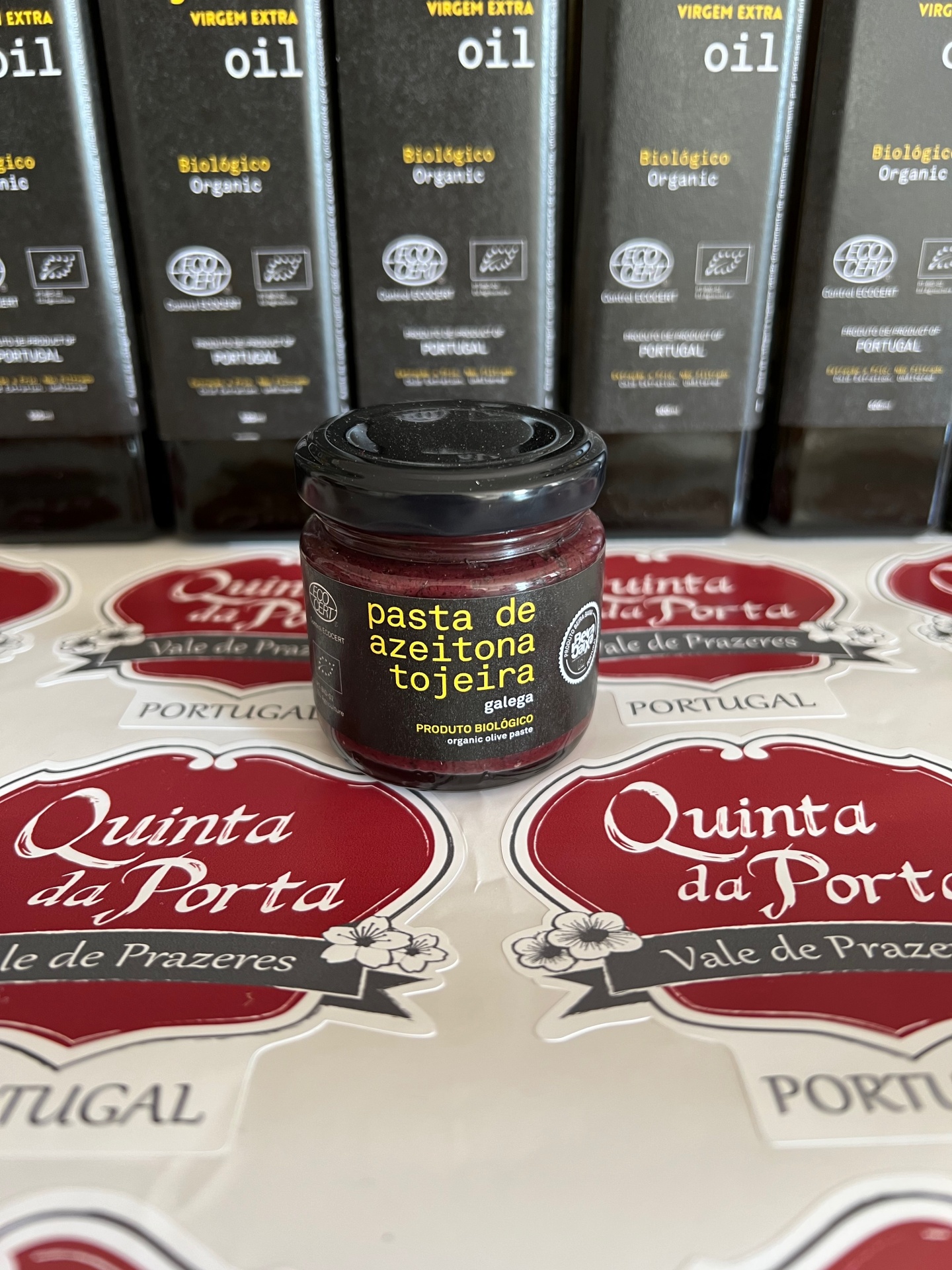 Azeitona Galega Tojeira (BIO) 400g Frasco de pasta de azeitona tojeira galega com etiquetas Quinta da Porta e embalagens de azeite biológico