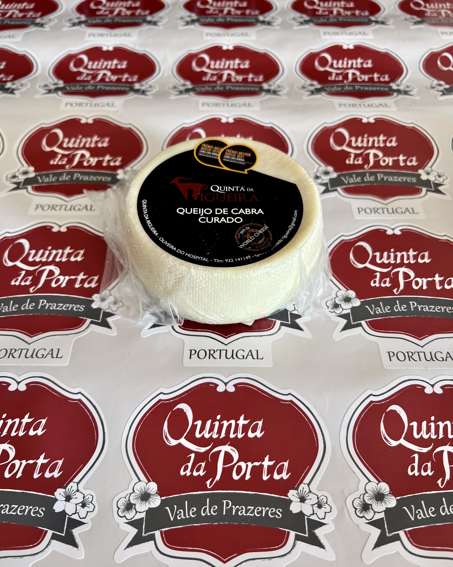Queijo de Cabra - Quinta da Rigueira Queijo de cabra curado embalado com etiqueta preta em papel com logotipo Quinta da Porta