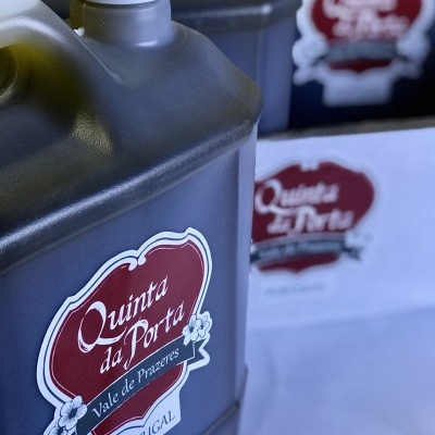 Garrafas plásticas cinza com rótulos vermelhos da marca Quinta da Porta