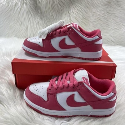 Sapatilhas Nike Dunk Low branco e rosa em caixa vermelha sobre superfície branca felpuda