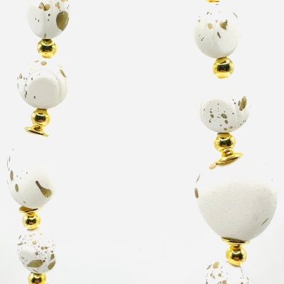 Colar com contas brancas e douradas em padrão salpicado.