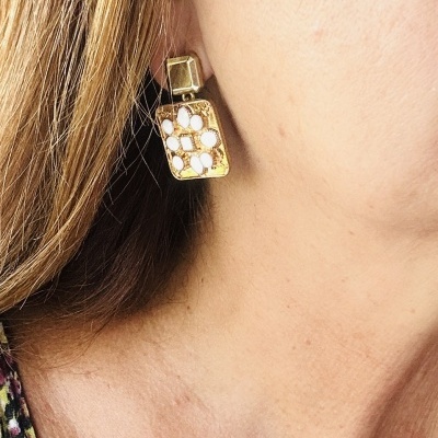 Brinco dourado pendente com padrão geométrico branco