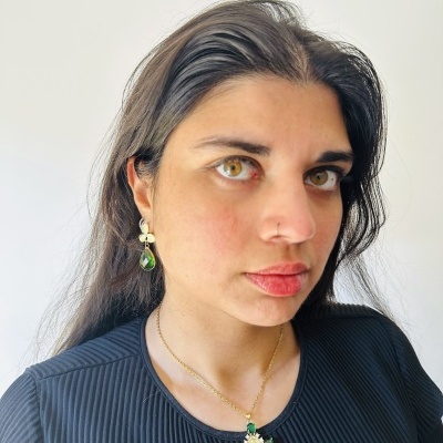 Mulher com colar e brincos de pedra verde em fundo branco