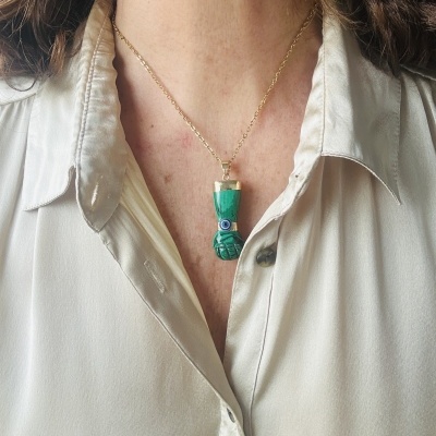 Colar com pendente em forma de punho verde com olho azul e branco, correntinha dourada