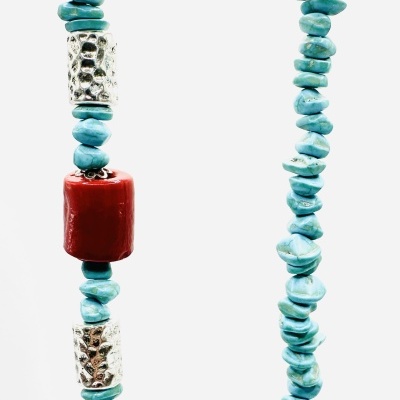 Colar com contas azuis irregulares, contas prateadas cilíndricas com relevo e uma conta vermelha grande central